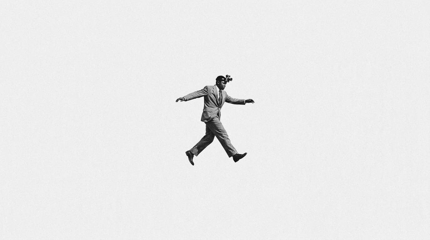 A man in a suit stepping through the air with a camera strapped to his forehead